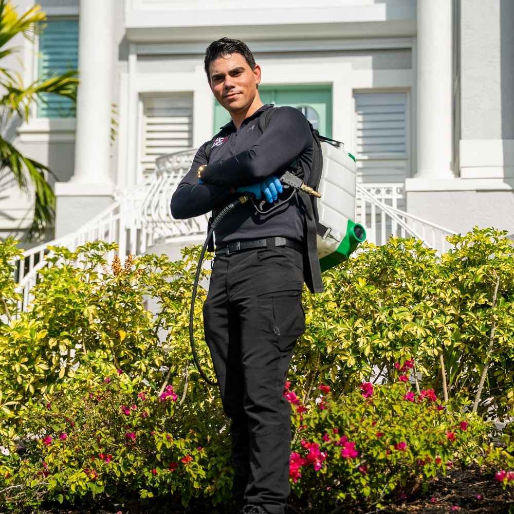 Pest-control technician outside a residential property